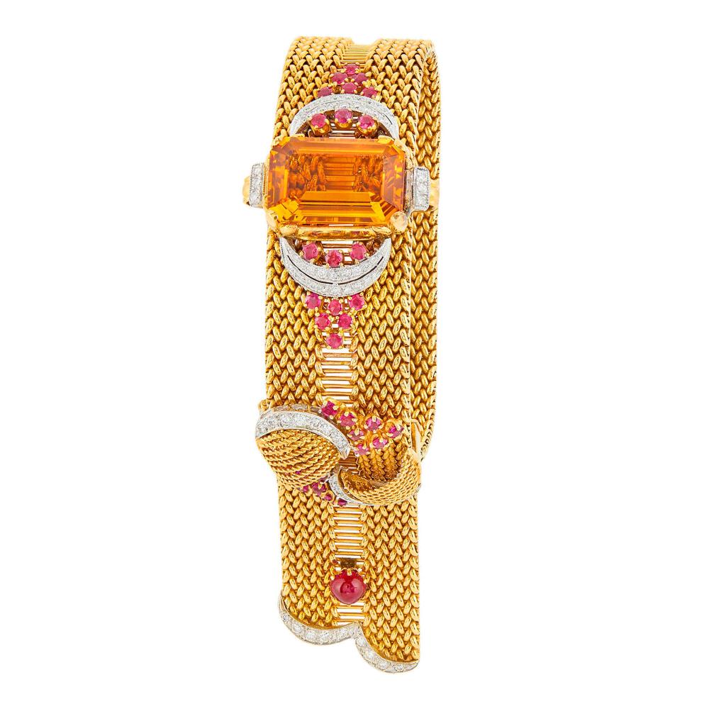 The Property of a Distinguished European CollectorOne cut-cornered step-cut emerald-cut citrine ap. 20.0 x 12.8 mm., 71 round diamonds ap. 1.30 cts., 32 small round rubies, one round cabochon ruby ap. 5.5 mm., circa 1950, ap. 58.7 dwts. Length adjustable.

Tests as 14 kt.Citrine: bright medium deep tangerine orange, very slightly included, very nice shape and cut, lively.Diamonds: H-I-VS.Rubies: bright medium deep raspberry, slightly to moderately included, very lively.Width 7/8 inch.                            
Any condition statement is given as a courtesy to a client, is an opinion and should not be treated as a statement of fact and our Organization shall have no responsibility for any error or omission. Please contact the specialist department to request further information or additional images that may be available.