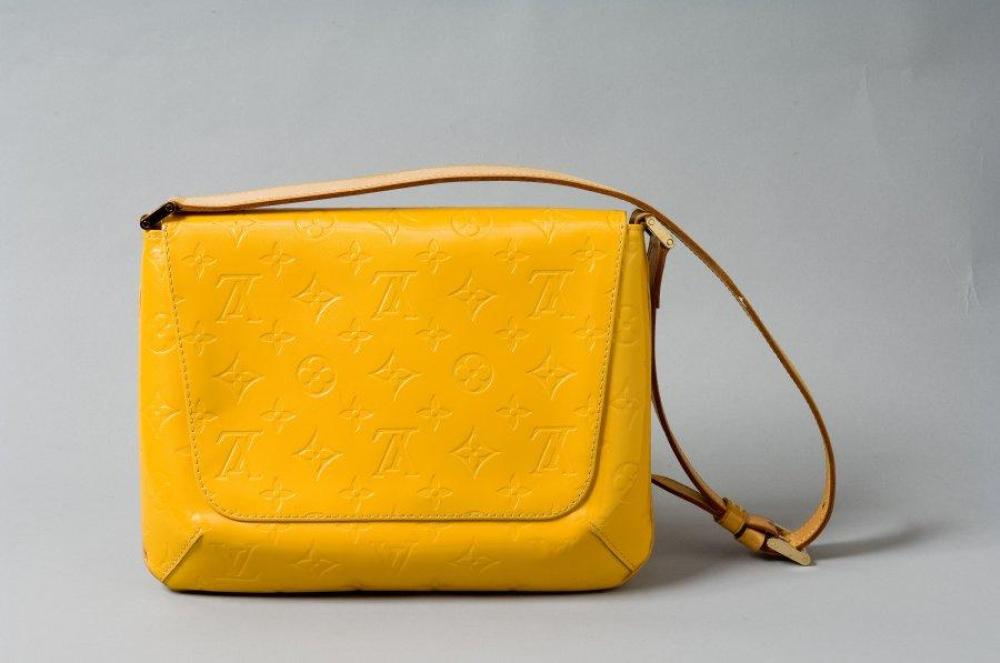 Louis VUITTON

Sac "Thompson Street" en cuir monogram vernis jaune et cuir naturel, fermoir pression sous rabat, anse règlable, poche intérieure