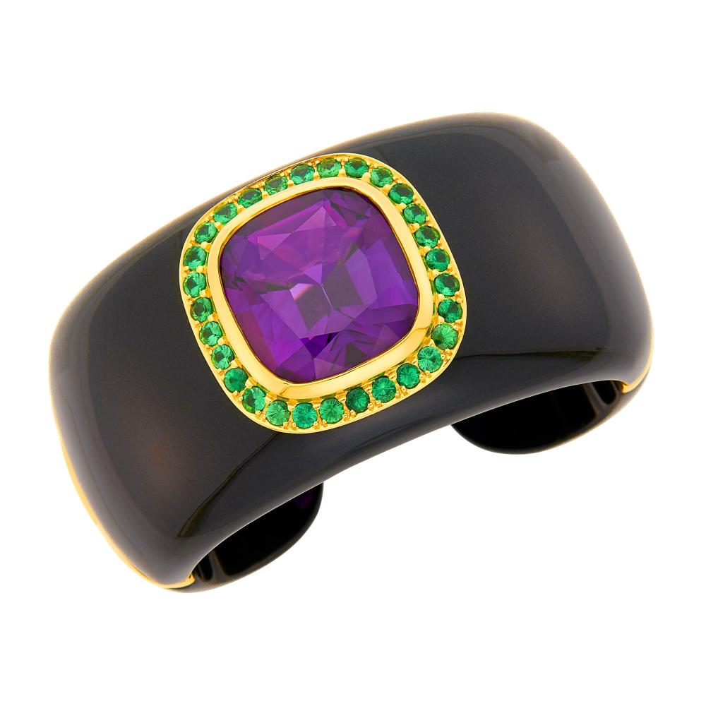 Property from the Collection of Augusta Patton18 kt., one square cushion-shaped amethyst ap. 38.25 cts., 29 round tsavorite garnets, with maker’s mark. Inner circle 6 1/2 inches, with open back.

Amethyst: deep purple, cleanish, light scratches on table, one small chip to table edge and one tip of culet, nice shape and cut, lively.Garnets: electric vivid green, slightly to moderately included, lively.Black jade: good luster.One back panel hinges. Width 1 9/16 inches.                            
Any condition statement is given as a courtesy to a client, is an opinion and should not be treated as a statement of fact and our Organization shall have no responsibility for any error or omission. Please contact the specialist department to request further information or additional images that may be available.