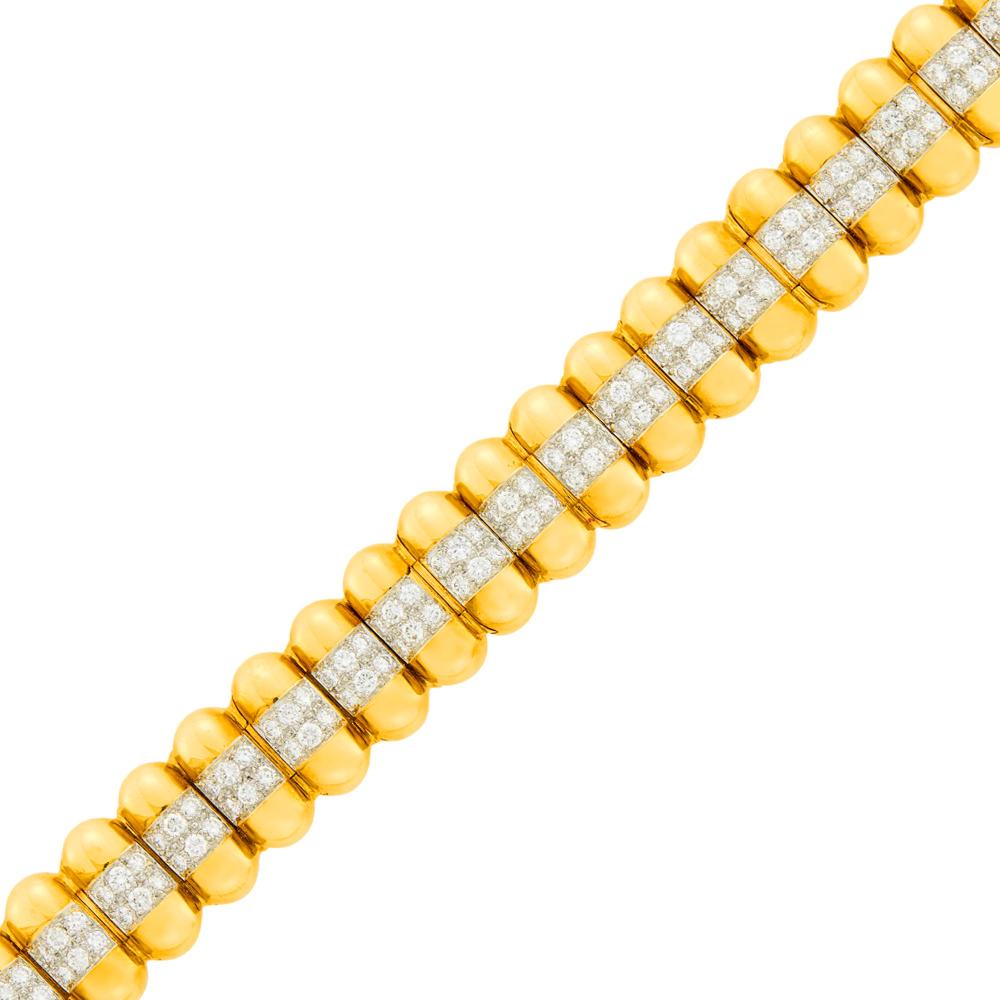 The Martin and Lynn Halbfinger Collection18 kt. yellow and white gold, 142 round diamonds ap. 5.65 cts., ap. 46 dwts. Length 6 1/4 inches.

Diamonds: H-I-VS.Width 5/8 inch.                            
Any condition statement is given as a courtesy to a client, is an opinion and should not be treated as a statement of fact and our Organization shall have no responsibility for any error or omission. Please contact the specialist department to request further information or additional images that may be available.