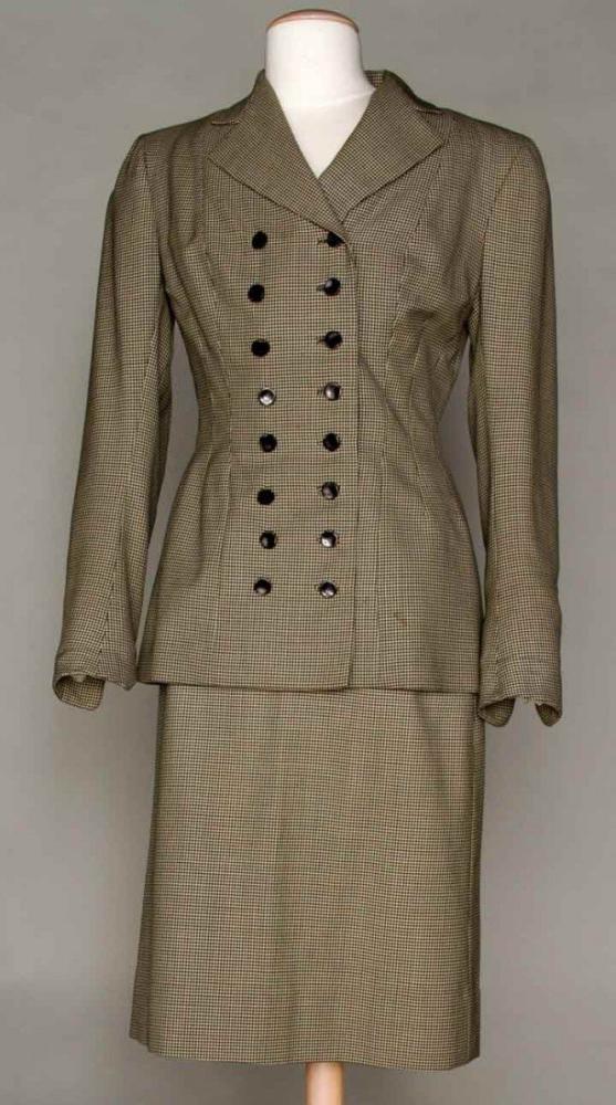 MANGONE WOOL SKIRT SUIT, 1945

Label "Mangone New York", black & white houndstooth jacket, double breasted, black buttons, B 38", L 28.5"; straight skirt, W 26", L 25", (light stain on front) very good. Brooklyn Museum