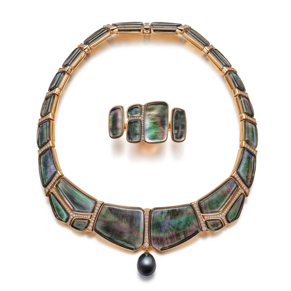 Hermès

Comprising: necklace set with carved mother-of-pearl panels, highlighted with brilliant-cut diamonds, suspending a drop-shaped cultured pearl, and a between-the-finger ring en suite.

Potential bidders who intend to export this lot are advised that certain permits may be required for export. If you are interested in this lot, please contact the Jewellery Department before bidding.