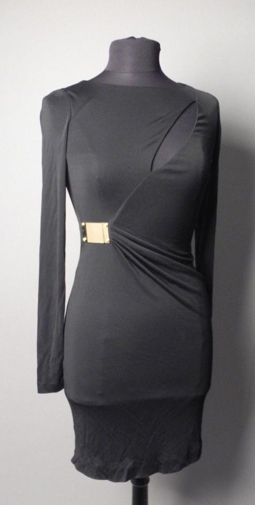 Emilio PUCCI

Robe courte de couleur noire ajourée au-dessus de la poitrine et d’une plaque siglée en métal doré marquant la taille Manches longues T. 36