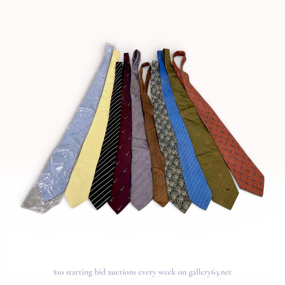 Description
A collection of eleven men’s designer neckties featuring examples from Gucci, Burberry, Giorgio Armani, and Yves Saint Laurent. The assortment includes various patterns such as equestrian motifs, diagonal stripes, foulard prints, and geometric designs, primarily constructed from silk. Labels and embroidered logos for the respective designers are present on several items, including a Gucci horsebit pattern and a Burberry heraldic crest motif.