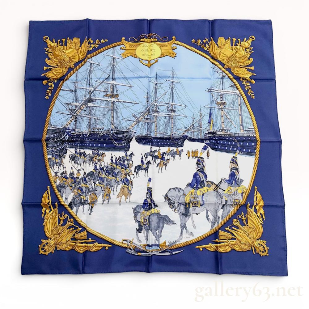 Description
Hermes silk carre in the Marine et Cavalerie pattern, designed by Philippe Ledoux and first issued in 1967. The design features a central historical military scene of the French cavalry and Dutch fleet surrounded by a rope border and ornate corner motifs. The scarf is constructed of silk twill with hand-rolled edges and includes the HERMES-PARIS signature, copyright mark, and artist signature.
Approximately 35 x 35 inches.