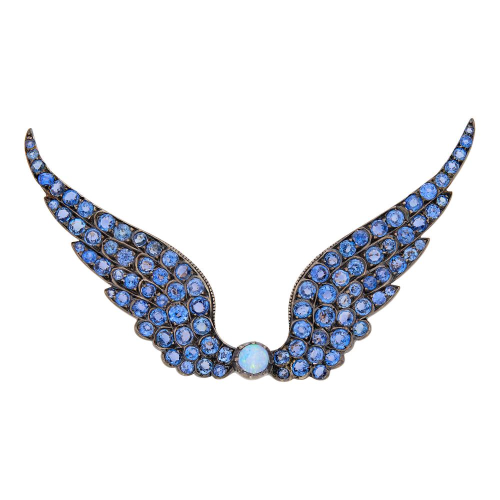 Property from a Prominent Maryland CollectionOne round opal ap. 4.6 mm., 94 round sapphires ap. 8.40 cts., circa 1890, ap. 9.7 dwts.

Opal: blue, green and faint red play-of-color, good polish.Sapphires: bright pastel slightly violetish cornflower blue, slightly included, lively.Nicely made. 3 1/8 x 1 7/8 inches.                            
Any condition statement is given as a courtesy to a client, is an opinion and should not be treated as a statement of fact and our Organization shall have no responsibility for any error or omission. Please contact the specialist department to request further information or additional images that may be available.