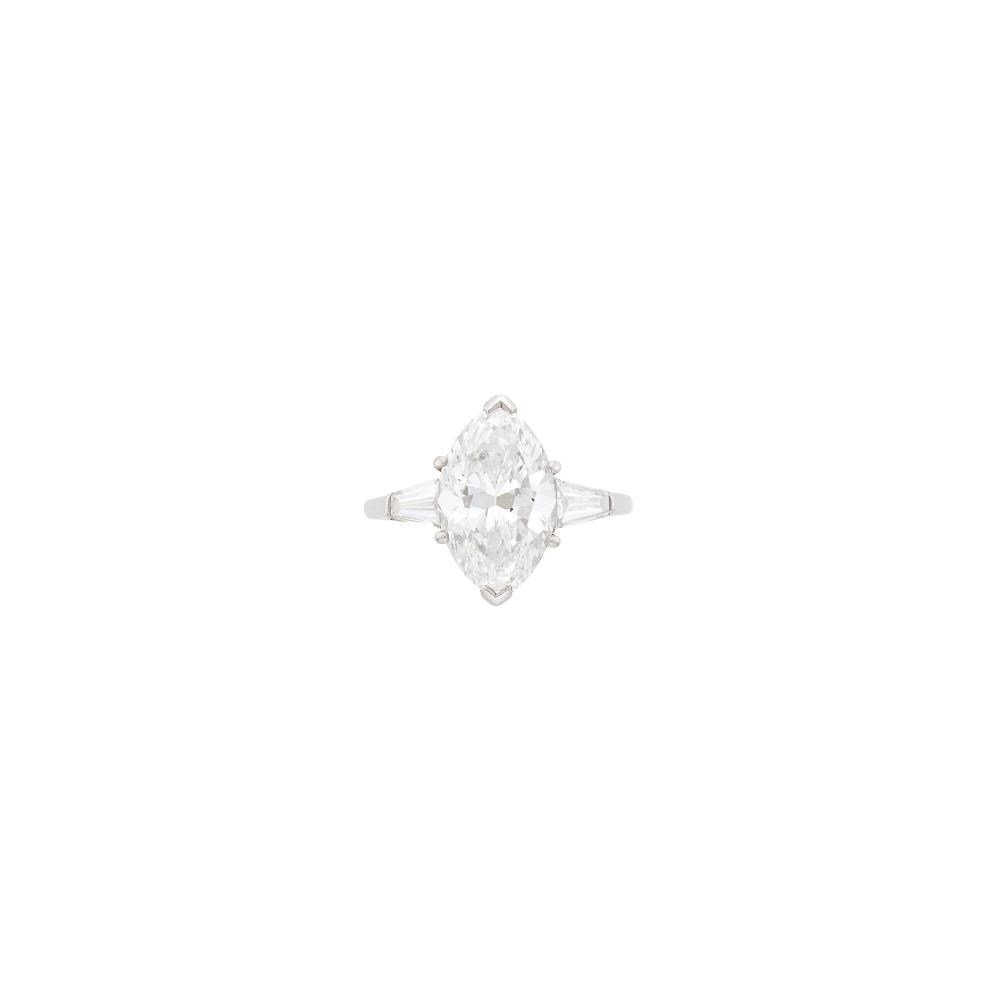 Property from the Estate of a Southern LadyOne marquise-shaped diamond weighing 4.91 cts., 2 tapered baguette diamonds. Size 7 1/4.
 
With GIA report no. 2235839677 stating E color, SI1 clarity.

Diamond: E-SI1, faint fluorescence, very nice shape and cut.                            
Any condition statement is given as a courtesy to a client, is an opinion and should not be treated as a statement of fact and our Organization shall have no responsibility for any error or omission. Please contact the specialist department to request further information or additional images that may be available.