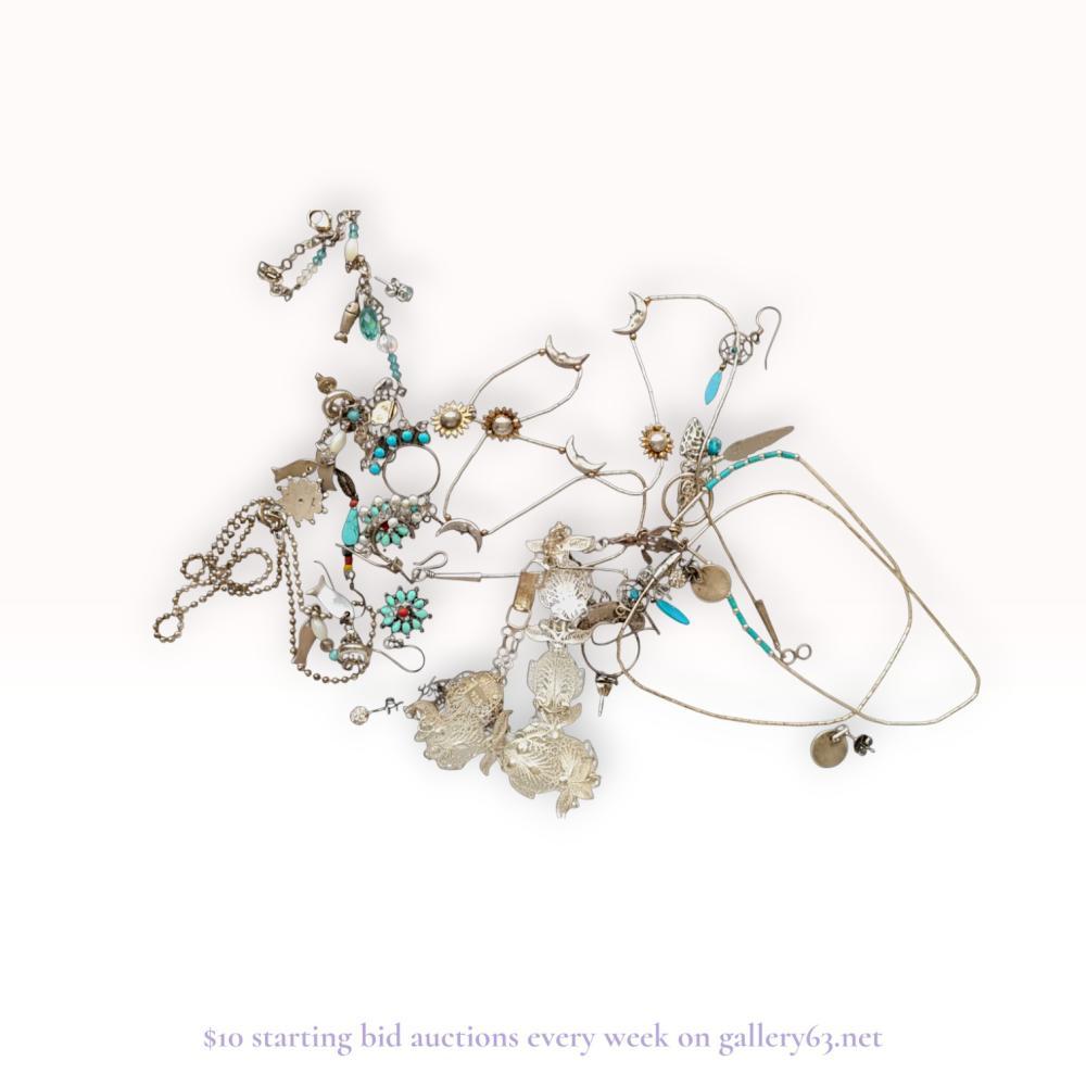 Description
This collection features various silver-tone jewelry pieces from the late 20th century to the contemporary era, including liquid silver, beaded, and filigree designs. Key items include a liquid silver necklace with crescent moon charms, a beaded necklace with a fish pendant, and a large intricate filigree ornament with floral motifs. Materials consist of white base metal, turquoise-colored stones, coral-hued accents, faux pearls, and faceted glass beads. Several components show stamped impressions on findings and clasps, though specific maker marks are not clearly legible.