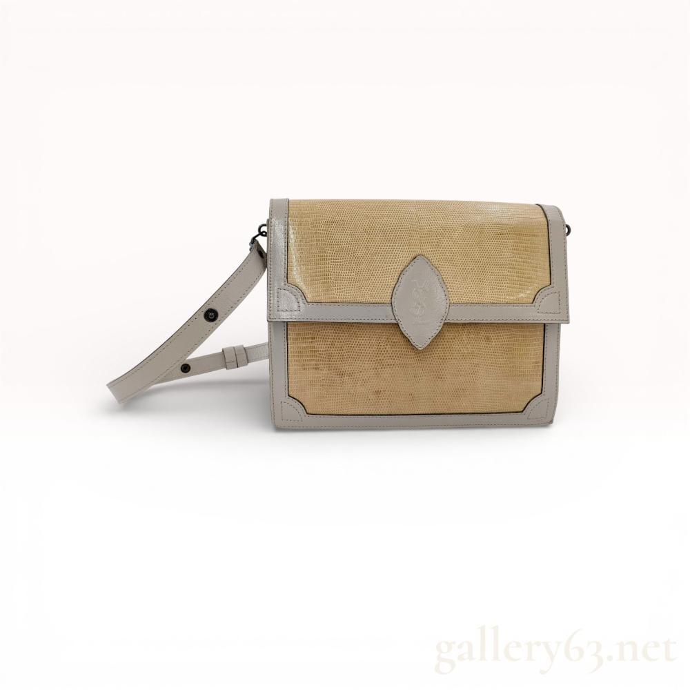 Description
Yves Saint Laurent vintage flap crossbody bag, late 20th century. The exterior is constructed with tan lizard skin front panels and taupe leather trim, featuring an adjustable shoulder strap and an embossed YSL monogram leather tab on the front flap. The interior is lined with signature YSL monogram jacquard fabric and includes a side zippered pocket with a gold foil brand stamp.
Approximately 8.5 inches W x 6.5 inches H.