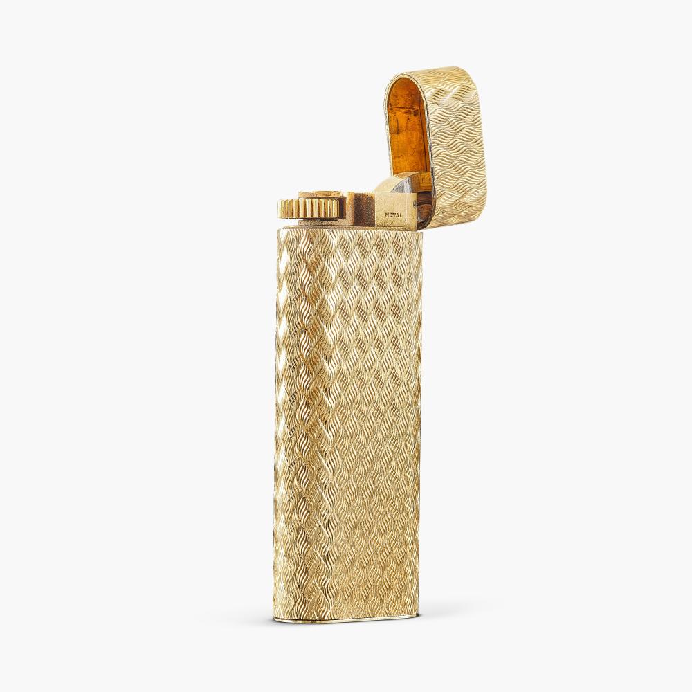 Cartier

The textured gold lighter with a hinged lid.
