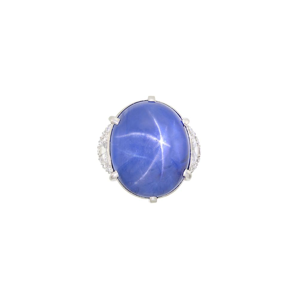 The Estate of a Baltimore FamilyOne oval star sapphire weighing 67.63 cts., 2 half-moon shaped diamonds ap. .70 ct., 14 round diamonds ap. .50 ct. Size 5 3/4.
The star sapphire has been weighed.

Sapphire: medium deep blue, medium strong centered six legged star, two legs slightly weaker, moderately included at one end, minor pitting, translucent, good polish.Half-moon diamonds: H-I-SI and I-J-I1.Diamonds: H-I-VS-SI.Width 1 inch.                            
Any condition statement is given as a courtesy to a client, is an opinion and should not be treated as a statement of fact and our Organization shall have no responsibility for any error or omission. Please contact the specialist department to request further information or additional images that may be available.