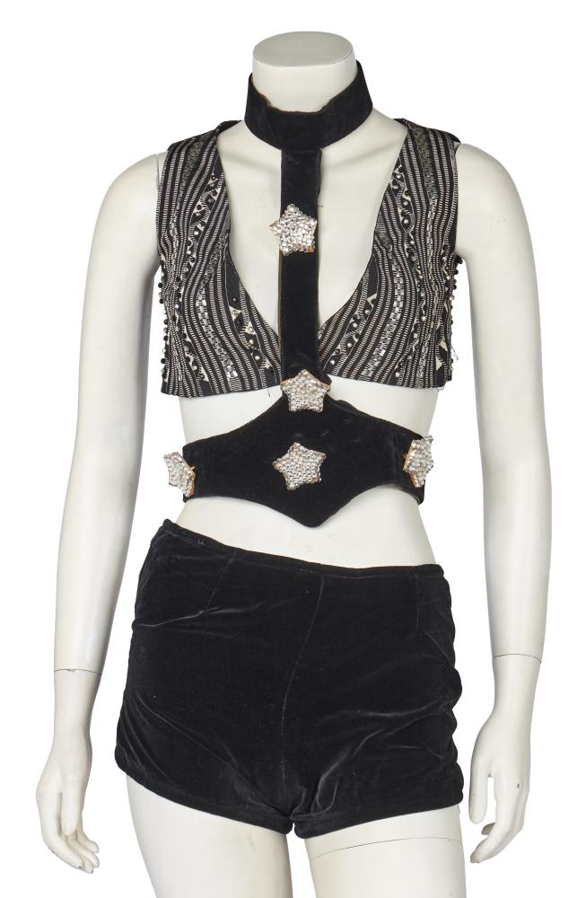 A group of Thea Porter separates, 1970s

A group of Thea Porter separates, 1970s

comprising: a blouse made from vintage gold lamé fabric, with neck ties, elasticated cuffs, Couture label, bust 91cm 36in; a black velvet waistcoat with gold braid edging; another of striped black and silver brocade with silver beads, both labelled, busts 81cm 32in; a pair of black velvet hotpants, waist 66cm 26in; and a black velvet and leather halterneck belt with attached star brooches (5)

Provenance: the late Lola Yearwood collection

Share this lot:
