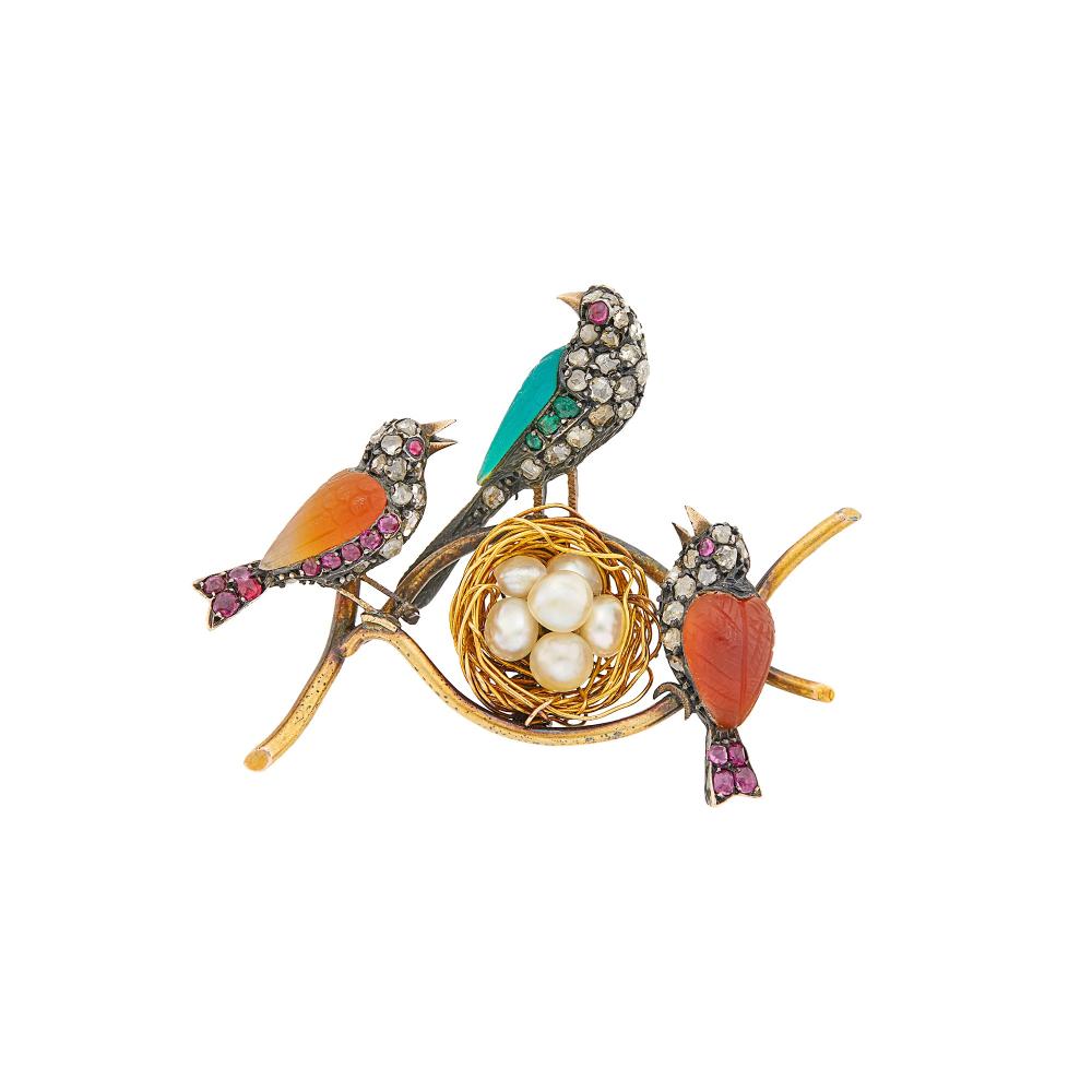 Property from a Prominent Maryland Collection6 semi-baroque pearls ap. 5.0 to 4.5 mm., rose-cut diamonds, small cushion-shaped rubies and emeralds, small round cabochon ruby eyes, carved orange and green stones, circa 1890, ap. 8.2 dwts.

Tests as 14 kt.Pearls: creamy white, blue overtone, slight dimples and rippling on several pearls, good luster.Rubies: medium slightly purplish red, slightly included.Emeralds: medium slightly blueish-green, slightly included.Diamonds: J-K-I, irregular.1 13/16 x 1 1/2 inches.                            
Any condition statement is given as a courtesy to a client, is an opinion and should not be treated as a statement of fact and our Organization shall have no responsibility for any error or omission. Please contact the specialist department to request further information or additional images that may be available.