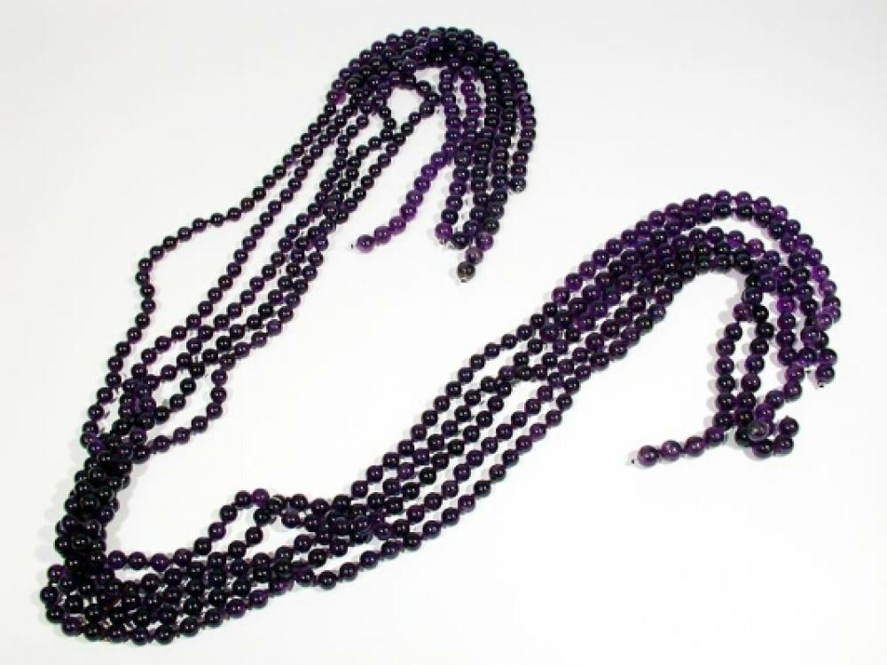 Faux Amethyst Bead Lariat

Lot 940
Faux Amethyst Bead Lariat
 Attributed to Yves Saint Laurent 
 Five strands of purple glass beads, length 48 inches.
