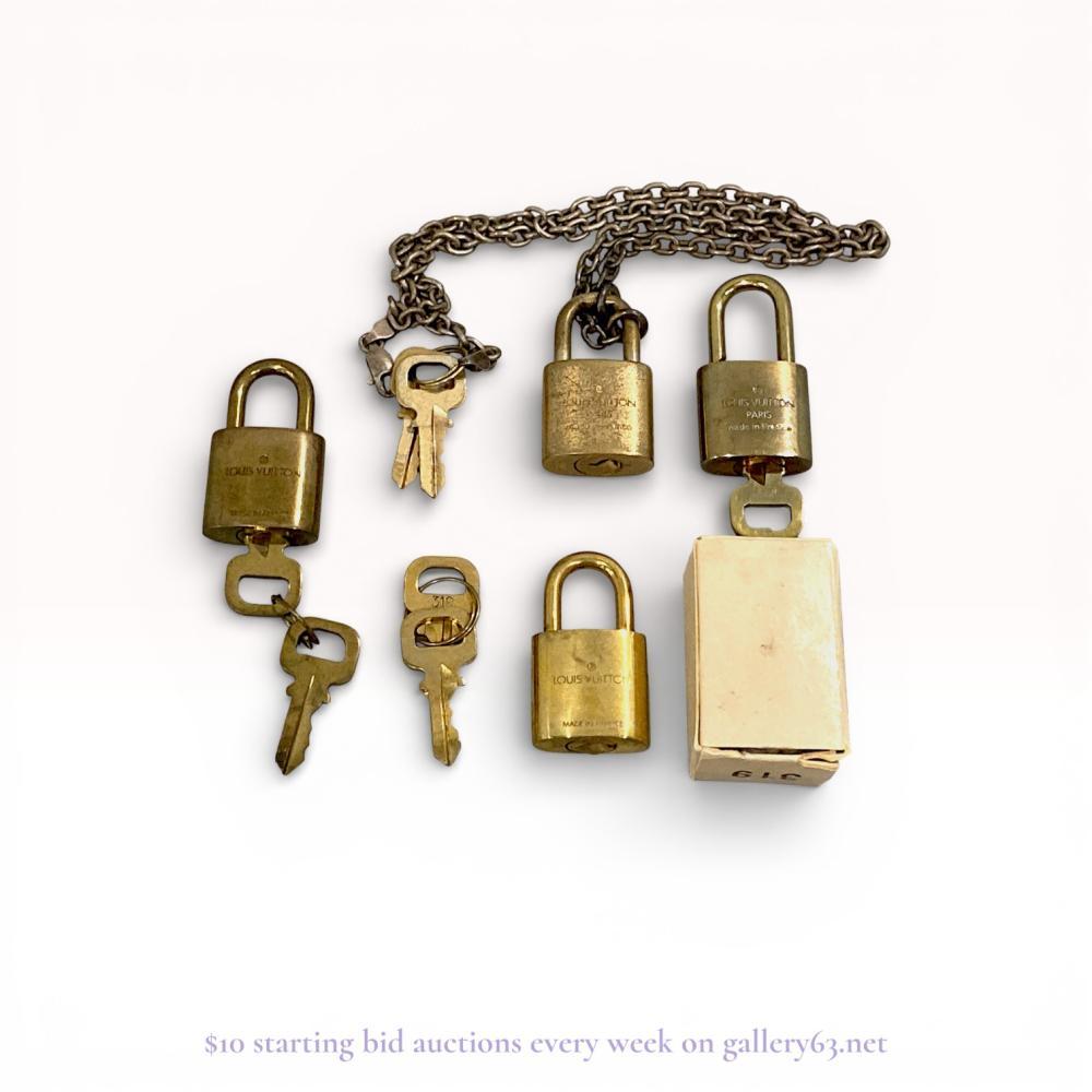 Description
Louis Vuitton brass luggage padlocks and assorted keys, late 20th century. The collection includes four padlocks featuring the embossed LV monogram and brand markings, including one lock and two keys numbered 319. Construction consists of brass lock bodies, metal keys, and one silver-tone metal chain. Stamped marks include LOUIS VUITTON, PARIS, made in France, and the registered trademark symbol.