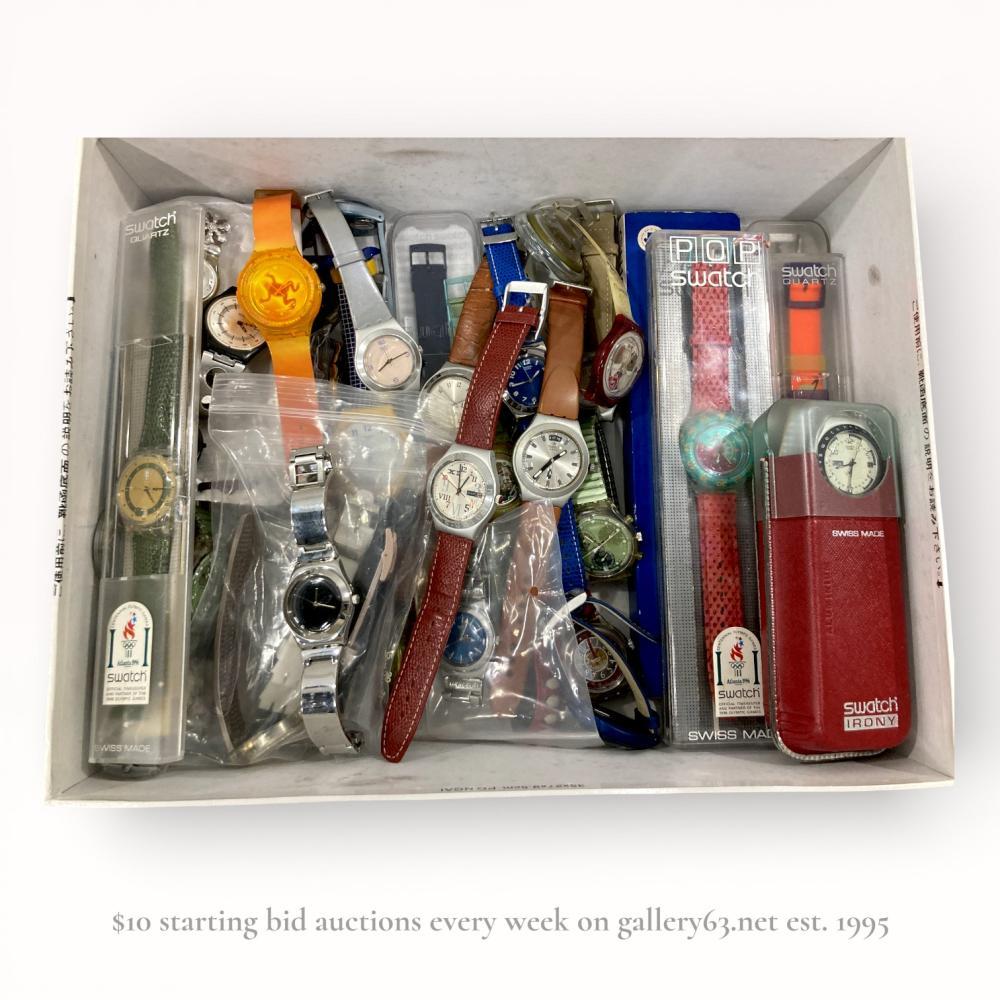 Description
A collection of approximately 25 Swatch quartz wristwatches, including various series and commemorative editions from the 1990s through the early 2000s. The assortment features Atlanta 1996 Olympic Centennial models, Swatch Irony stainless steel and aluminum examples, a POP Swatch, and a #swatchme Gent model with a yellow plastic case. Construction materials include plastic, stainless steel, aluminum, leather, and silicone, with several examples retaining original manufacturer packaging.
Case sizes range from approximately 34mm to 40mm.