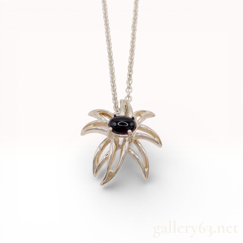 Description
Tiffany and Co. Fireworks pendant necklace, dated 1995. The sterling silver pendant features an abstract sculptural form with ten radiating arms centering a four-prong set oval black onyx cabochon. It is suspended from a fine cable link chain with a spring ring clasp. Hallmarks include TIFFANY&CO., ©1995, and 925 on the metal tags and clasp.
Chain length: 18 inches
Pendant: 22mm x 22mm.