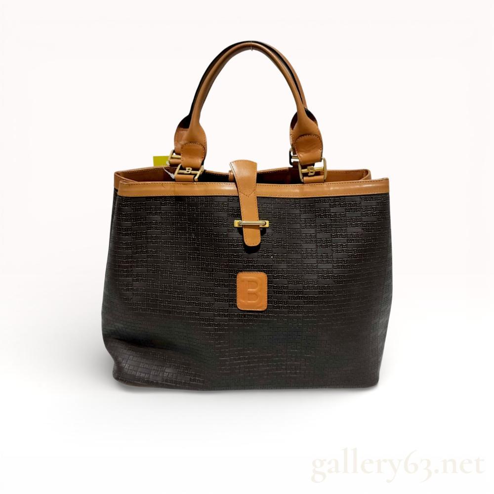 Description
Bally monogram top handle tote bag, late 20th century. The exterior is constructed from dark brown embossed material featuring an all-over logo pattern with smooth tan leather trim and gold-tone hardware. Key features include a front tab closure with a metal bar engraved BALLY, a central leather patch with an embossed B, and an interior leather tag marked BALLY MADE IN ITALY.
Width: 12 inches
Height: 9.5 inches
Depth: 4 inches.