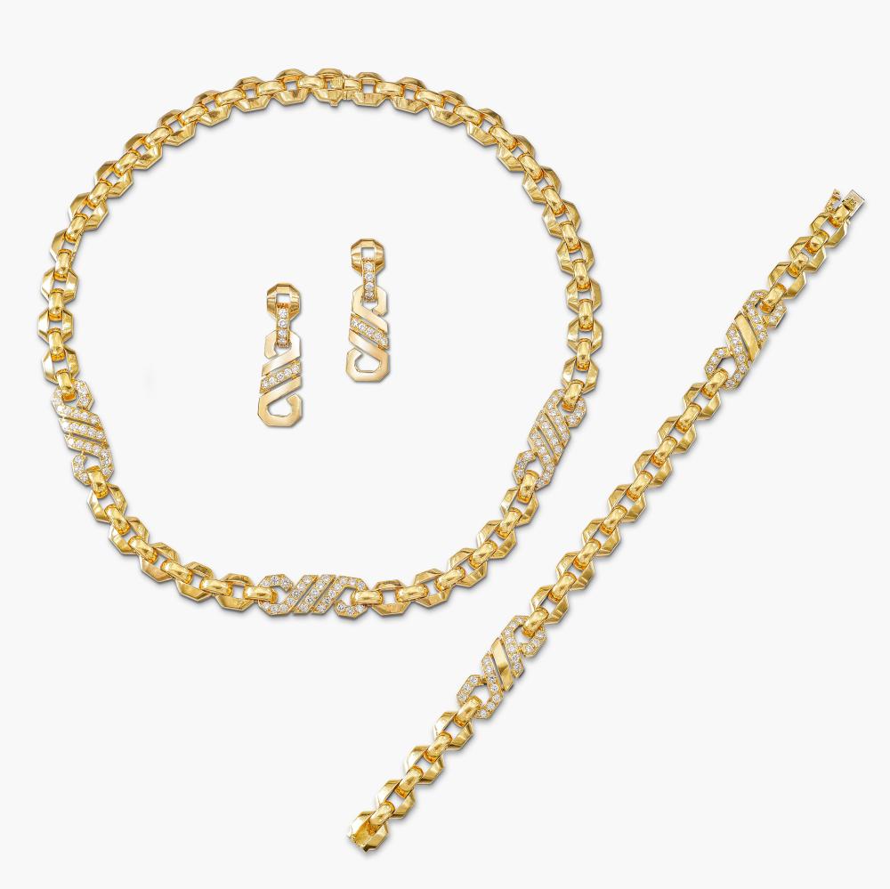Cartier

Comprising: the polished gold chain set with spacers of twisted rope design, decorated with brilliant-cut diamonds, a bracelet and pair of ear clips en suite.