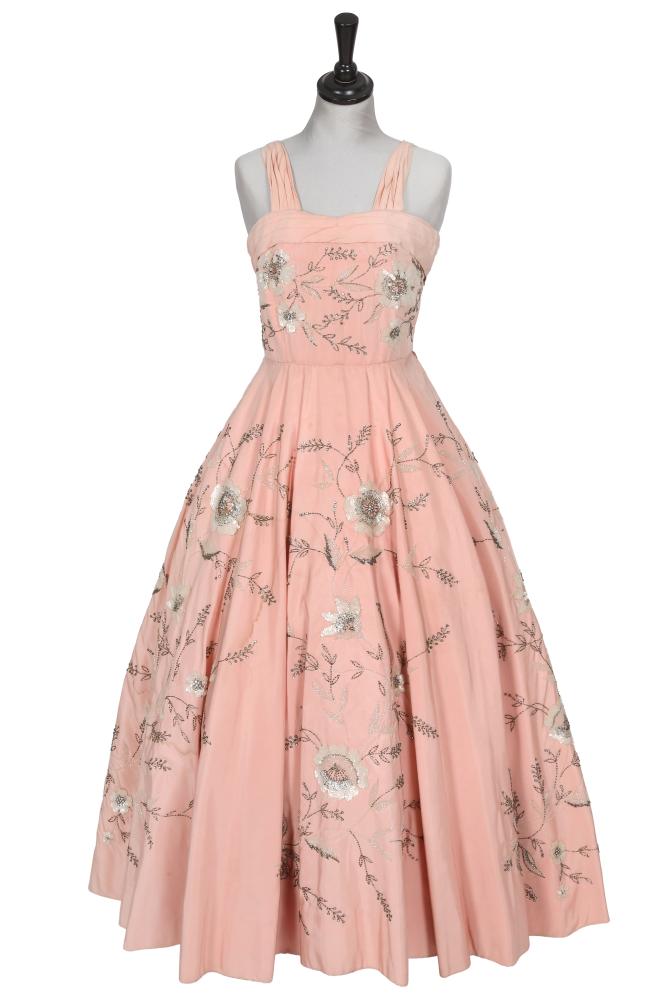 A Paquin/Worth embellished pink faille ballgown, circa 1955

A Paquin/Worth embellished pink faille ballgown, circa 1955

Paquin labelled, the boned bodice with pleated neckline and straps, the full skirt heavily embellished with beads and sequins depicting trailing flowers, ribbons and bows, waist 66cm 26in

In 1954, the House of Paquin merged with the House of Worth. A nearly identical gown to this one is in the collection of the Victoria & Albert Museum, accession no. T.214&A-1973, with a Worth label. The gown in the V&A was designed by Owen Hyde Clark for Worth London, and the embellishment is to silk dupion rather than silk faille.

Paquin-Worth closed in 1956.

Share this lot:
