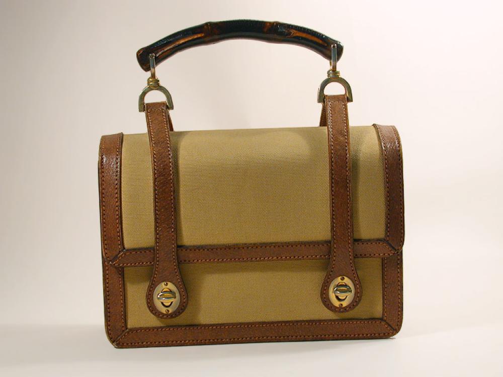 Gucci Canvas and Pigskin Handbag

Lot 873
Gucci Canvas and Pigskin Handbag
 Italian, 1960s 
 Khaki canvas with tan pigskin trim, bamboo handle attached to two straps affixed to front flap, gilt-metal closures and hardware, 8 1/2 x 6 inches, labeled: Made in Italy/by Gucci. 
Very good condition.