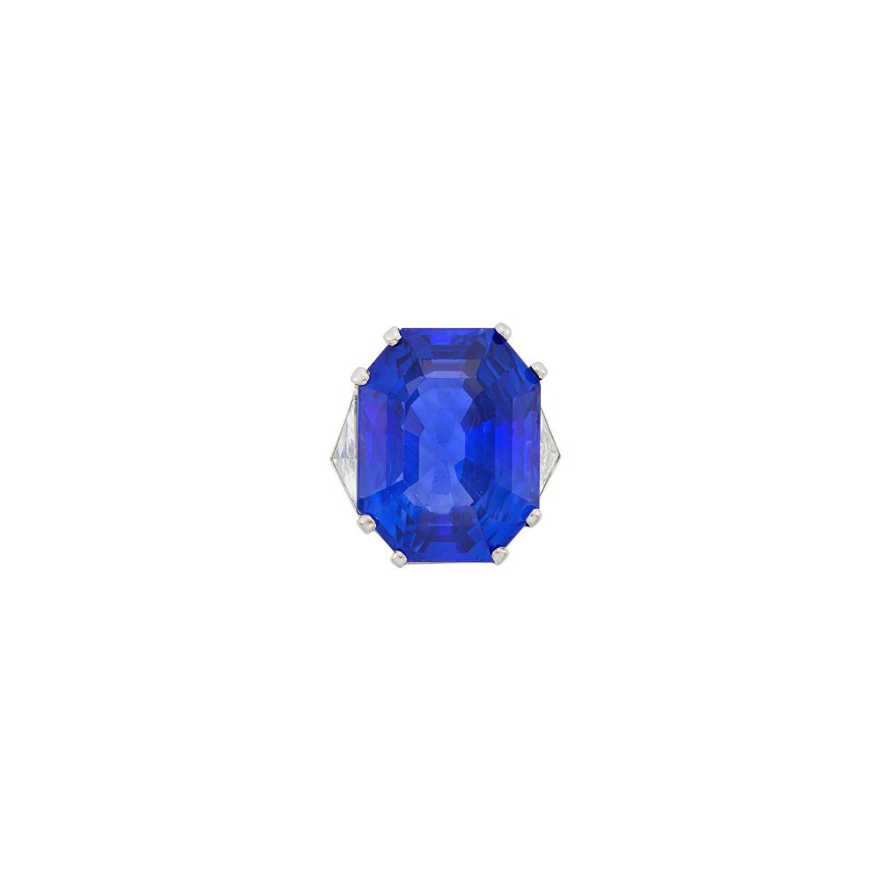 Collection of a Prominent Palm Beach LadyOne cut-cornered step-cut emerald-cut sapphire weighing 36.44 cts., 2 triangle-shaped diamonds, with French assay mark, slightly obscured. Size 5 1/4.
 
With AGL report no. 1152936 stating Ceylon (Sri Lanka) origin, with no gemological evidence of heat.

Sapphire: medium to medium deep blue, brighter blue highlights, silk across table, two abrasion patches on either side of culet, several light scratches on table, several minor nicks and abrasions on table edge and facet junctions, lovely cut, lively.                            
Any condition statement is given as a courtesy to a client, is an opinion and should not be treated as a statement of fact and our Organization shall have no responsibility for any error or omission. Please contact the specialist department to request further information or additional images that may be available.