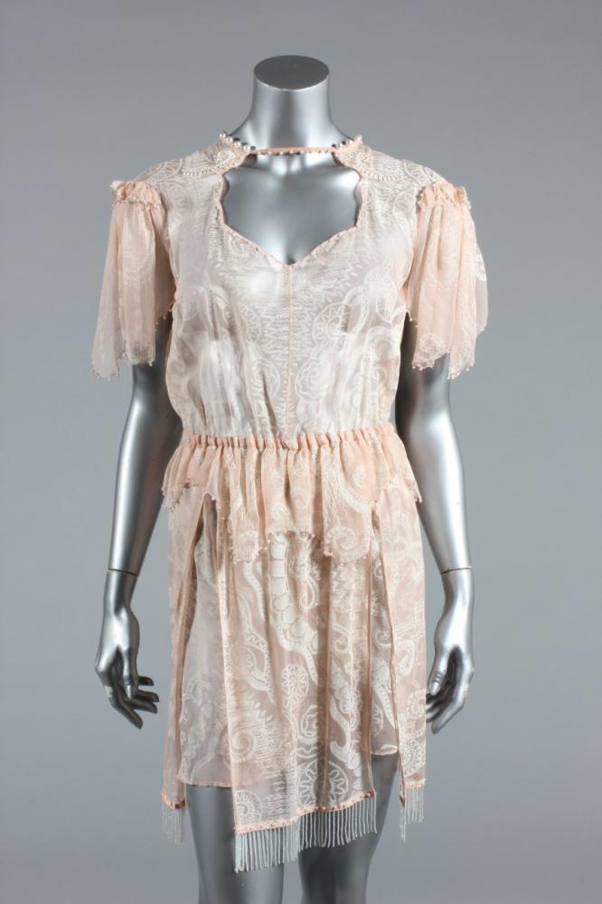 

A Zandra Rhodes printed pink chiffon cocktail dress/tunic, mid 1980s, labelled, edged with pearl beads and fringes, approx bust 86-92cm, 34-36in, elasticated waist
