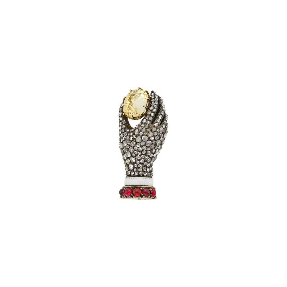 Property from a Prominent Maryland CollectionOne cushion-shaped yellow sapphire ap. 3.50 cts., rose-cut diamonds, 5 round cabochon rubies, circa 1880, ap. 7.8 dwts.

Gold base tests as 18 kt.Yellow sapphire: light yellow, cleanish, minor table and facet edge abrasions, lively.1 1/8 x 1/2 inches.                            
Any condition statement is given as a courtesy to a client, is an opinion and should not be treated as a statement of fact and our Organization shall have no responsibility for any error or omission. Please contact the specialist department to request further information or additional images that may be available.