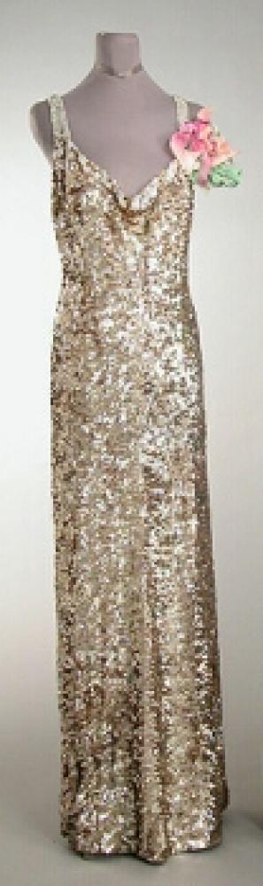 Worth Iridescent Sequined Evening Gown

Lot 516
Worth Iridescent Sequined Evening Gown
 French, 1930s 
 With sweetheart neckline, rhinestone straps, low V back, mousseline embroidered with pale green, purple and gold, sequins, size 8, labeled: Worth. 
Good condition, some losses to sequins, possibly shortened and interior flounce re-sewn.