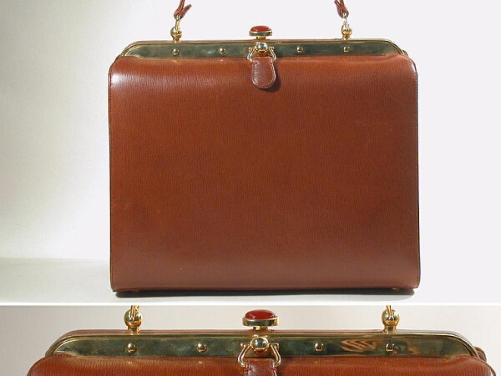 Judith Leiber Leather Daybag

Lot 867
Judith Leiber Leather Daybag
 Of rectangular shape, cinnamon leather tailored body and strap, with gilt-metal studded frame and push carnelian clasp, 9 x 7 1/2 inches, labeled: Judith Leiber.
Excellent condition.