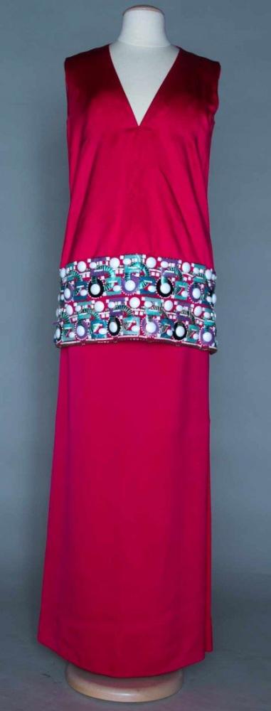 PIERRE CARDIN JEWELED EVENING GOWN, c. 1965

2-piece, cherry red double weave satin: sleeveless, V neck tunic w/ multi-colored jeweled, beaded & irridescent plastic circles & squares, double panel long straight skirt, deep side slits, B 36"’ W 2