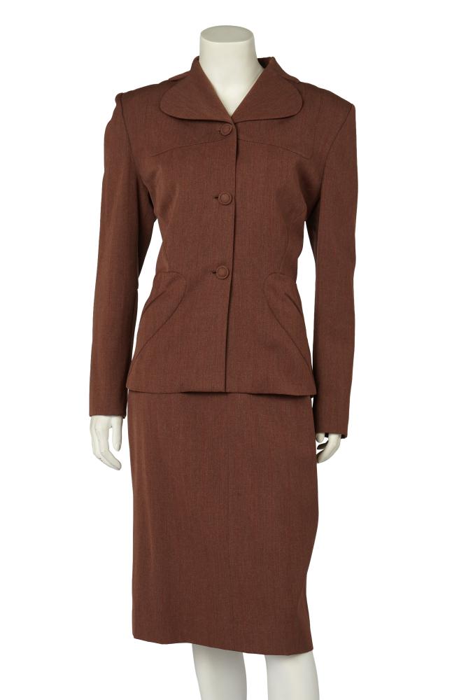 A Gilbert Adrian brown and red striped Samek wool suit, 1940s

A Gilbert Adrian brown and red striped Samek wool suit, 1940s

British Samek Material label, the jacket with short curved lapels, self-covered buttons, curved panels to chest and hips, padded shoulders, bust 96cm 38in; with matching skirt, waist 71cm 28in (2)

Share this lot:
