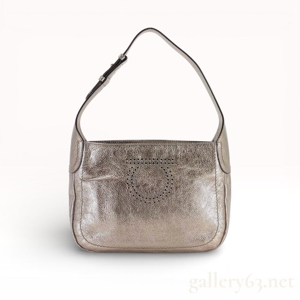 Description
Salvatore Ferragamo hobo-style shoulder bag crafted from metallic silver crinkled leather. The exterior features a centrally placed perforated double Gancini logo and an integrated adjustable shoulder strap with a silver-tone buckle. The interior is lined in black grosgrain fabric with one zippered pocket and a silver-tone metal brand plaque marked Salvatore Ferragamo Made in Italy.
11 inches W x 8 inches H x 3 inches D.