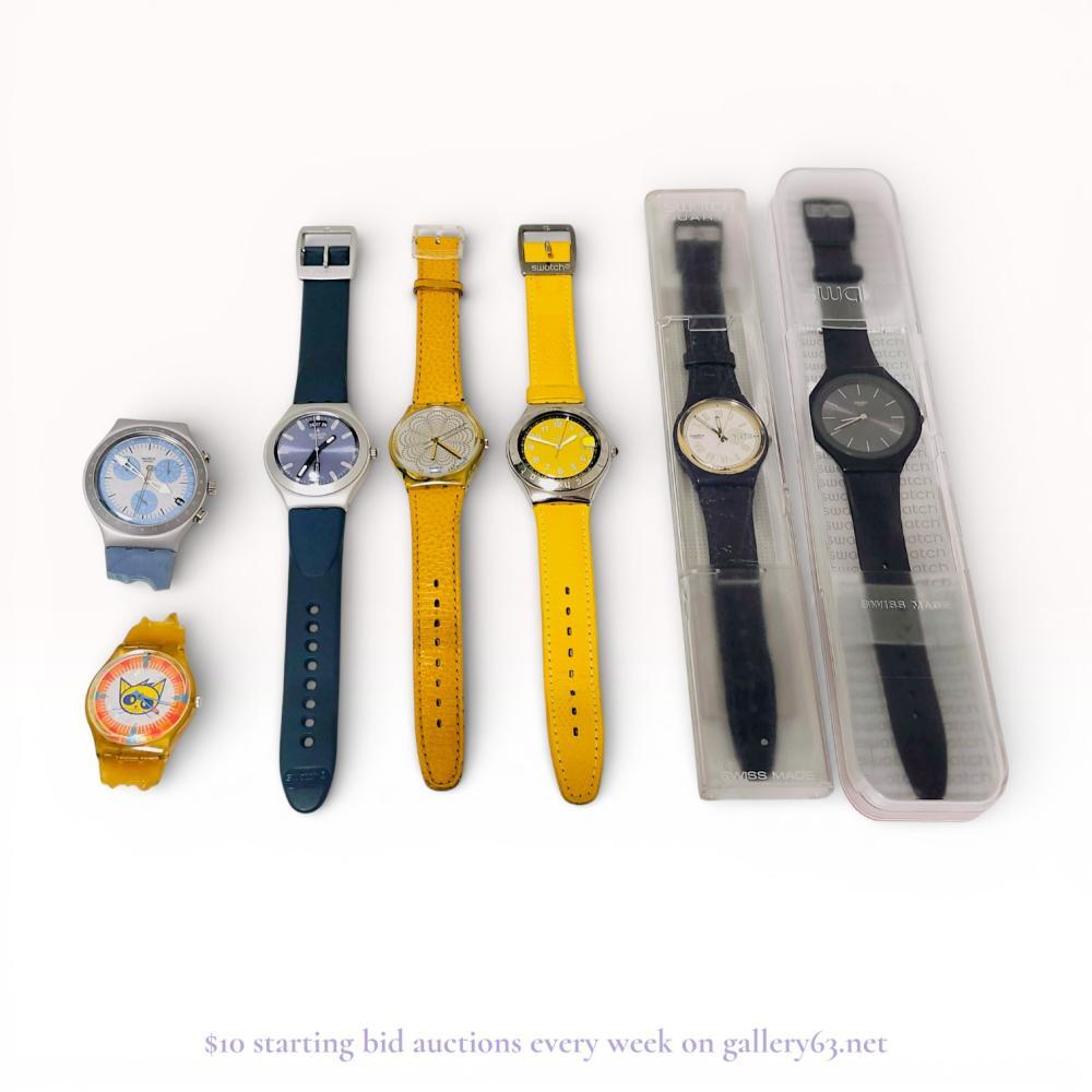 Description
A collection of seven Swatch quartz wristwatches including Irony Chronograph, Irony Day-Date, and Happy Joe Yellow YGS409C models, circa 1991-2000. The group features stainless steel and plastic cases with diverse dial motifs including a Pop Swatch cat illustration, sunburst finishes, and Roman numerals. Dials and case backs bear Swatch Swiss markings and copyright dates including 1991 and 2000. Two watches are presented in original clear plastic display cases.
Case sizes range from 34mm to 43mm.