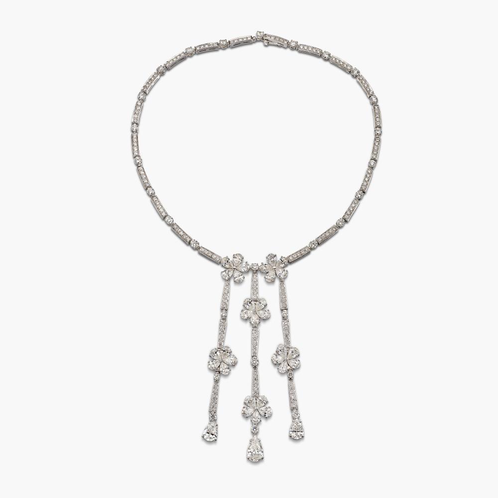 Bulgari

Suspending three fringes of flowerheads, the petals set with pear-shaped diamonds, accented throughout with brilliant-cut diamonds.