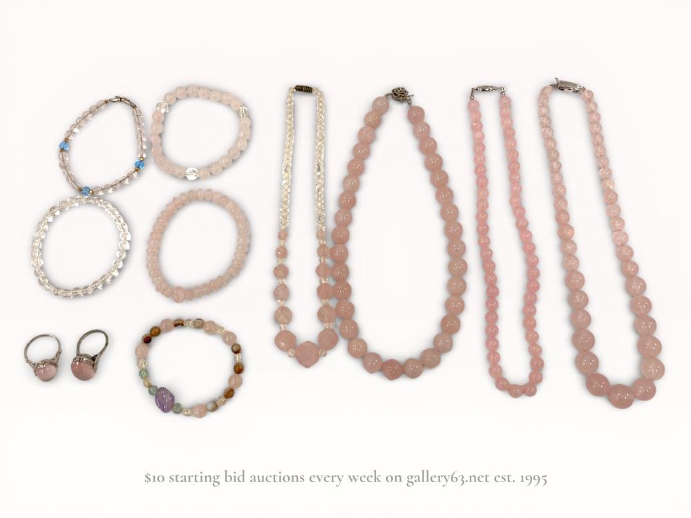 Description
A ten-piece collection of estate jewelry primarily featuring rose quartz and rock crystal beads. The group includes necklaces with graduated and uniform beads featuring barrel screw and fishhook clasps, bracelets in stretch and lobster claw styles, and rings set with oval rose quartz cabochons in decorative openwork baskets with multi-prong mounts. Materials include rose quartz, rock crystal, amethyst, agate, and plated base metals, with one necklace clasp stamped GSILVER for German Silver, a nickel-brass alloy.