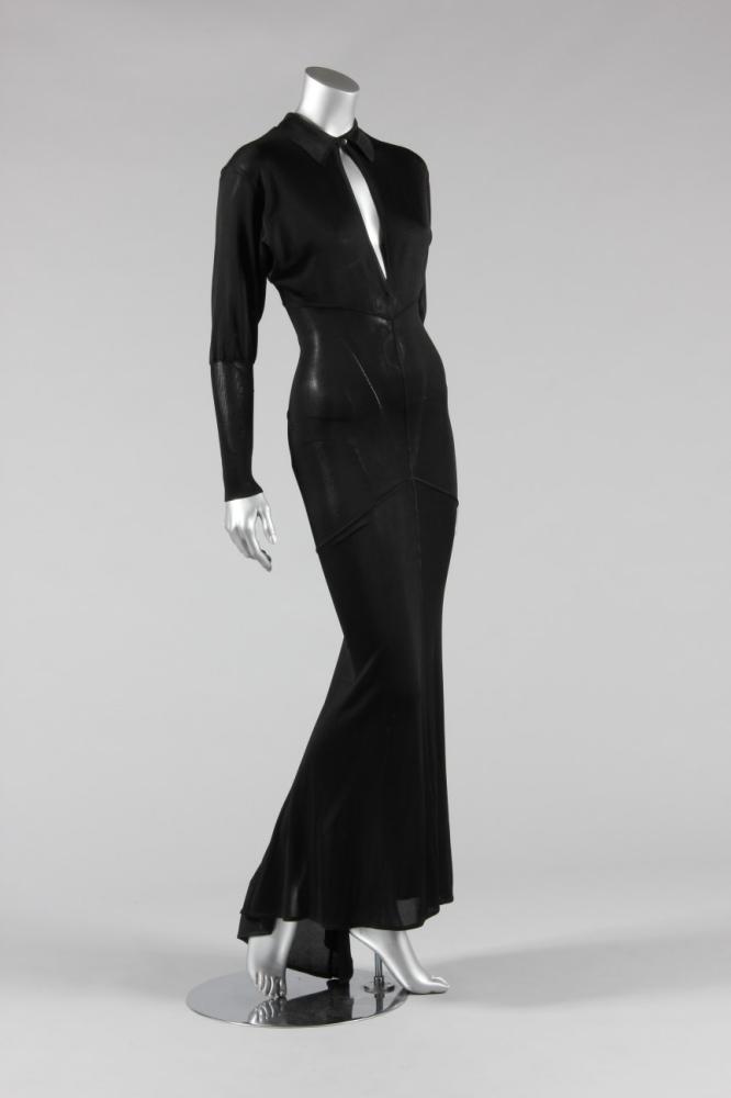 

An Azzedine Alablack knitted silk body-con evening gown, early 1990s, labelled and size M, with single button to collar, sculpted and gored panels which follow the contours of the body, bust approx 86cm, 34in
