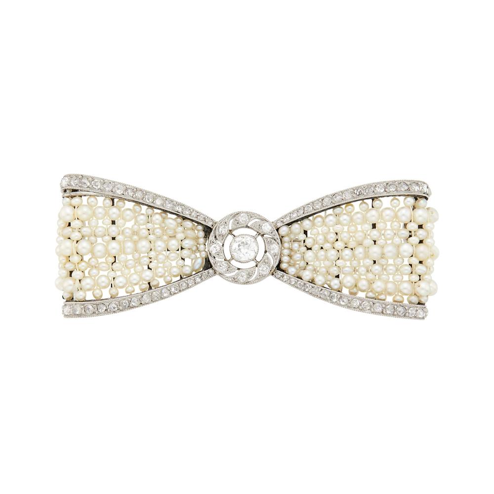 Property from a Prominent Maryland CollectionOne old European-cut diamond ap. .20 ct., 8 small old-mine and numerous rose-cut diamonds, signed Cartier Paris, no. 5912, Déposé, with French assay mark, circa 1910, ap. 8 dwts.

Center diamond: G-H-I-SI.Pearls: slightly creamy with rose and green orient, round to oval to donut-shaped, good luster.2 3/8 x 7/8 inches.                            
Any condition statement is given as a courtesy to a client, is an opinion and should not be treated as a statement of fact and our Organization shall have no responsibility for any error or omission. Please contact the specialist department to request further information or additional images that may be available.