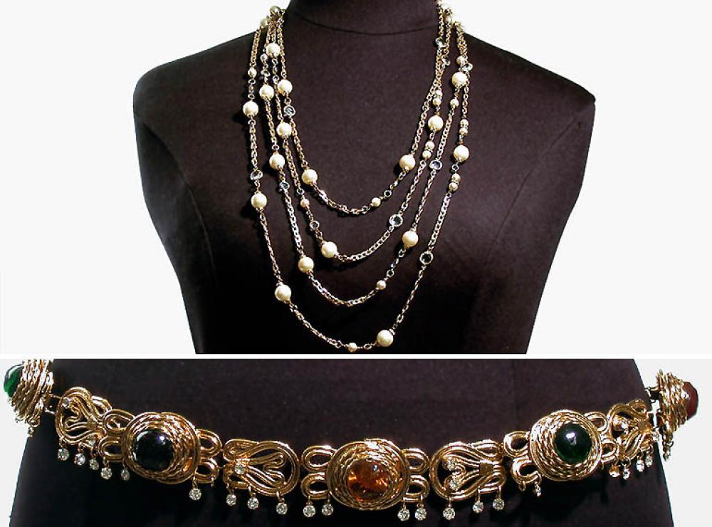 Chanel Belt and Necklace

Lot 941
Chanel Belt and Necklace
 The belt of gilt-metal scroll links inset with emerald and ruby pate de verre, with dangling rhinestones, length 34 inches, signed: Chanel 96; the long necklace of gilt-metal links with faux pearls and crystals, length 57 inches.