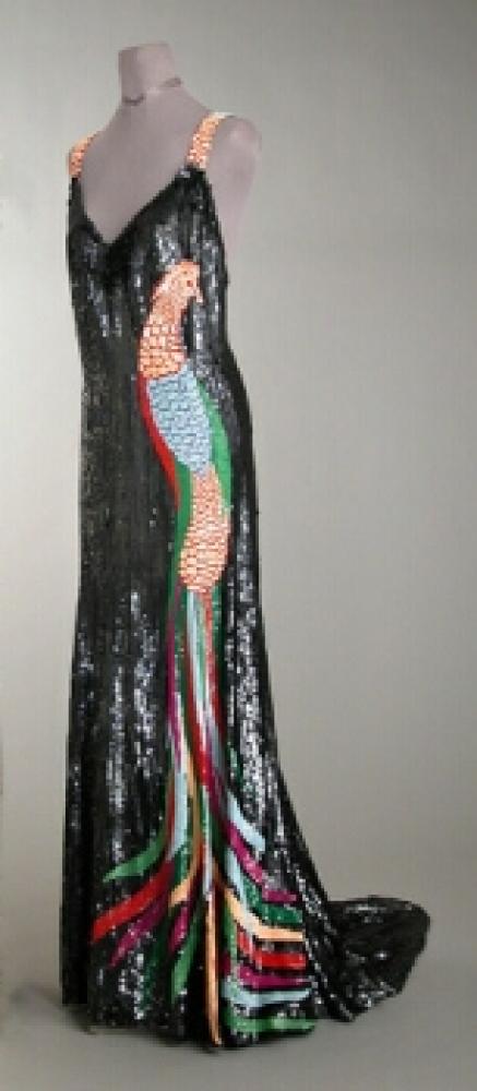 Worth Bird of Paradise Sequined Evening Gown

Lot 521
Worth Bird of Paradise Sequined Evening Gown
 French, 1930s 
 The sheath with sweetheart neckline, low back, fullness from back hip flowing into train, mousseline embroidered with pewter sequins and full length bird of paradise at one side, the straps worked in feather design at back, size 8: Worth woven into inner waistband. 
Excellent condition.