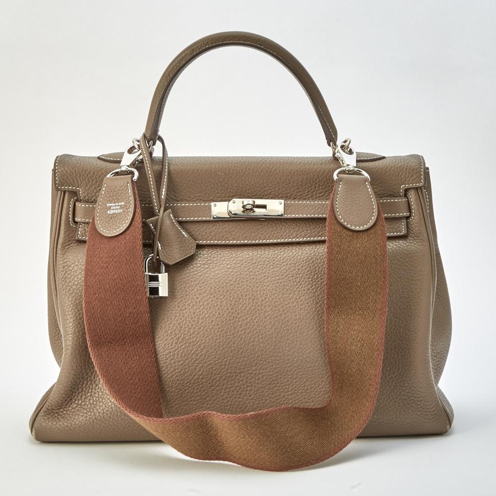 A Distinguished Calabasas FamilyTop handle bag with palladium hardware and turn-lock closure, lock, keys and clochette, matching leather interior with one side zippered pocket and two slip pockets, with detachable fabric strap, signed Hermès, c. 2010. 14 x 9 1/4 x 4 1/4 inches.

Moderate wear. Relaxed leather. Scuffing on bottom corners. Minor wear on top handle. Blue pen mark under front flap.                            
Any condition statement is given as a courtesy to a client, is an opinion and should not be treated as a statement of fact and our Organization shall have no responsibility for any error or omission. Please contact the specialist department to request further information or additional images that may be available.