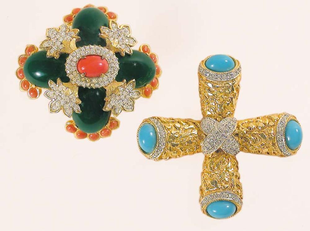 Two Kenneth Jay Lane Brooches

Lot 917
Two Kenneth Jay Lane Brooches
 American, mid 1960s 
 The first of textured cruciform gilt-metal with oval turquoise colored stones terminals on each arm and diamante accents; the second of flowerhead form with coral colored center, faux jade petals, diamante and coral colored stone trim, both marked: KJL.