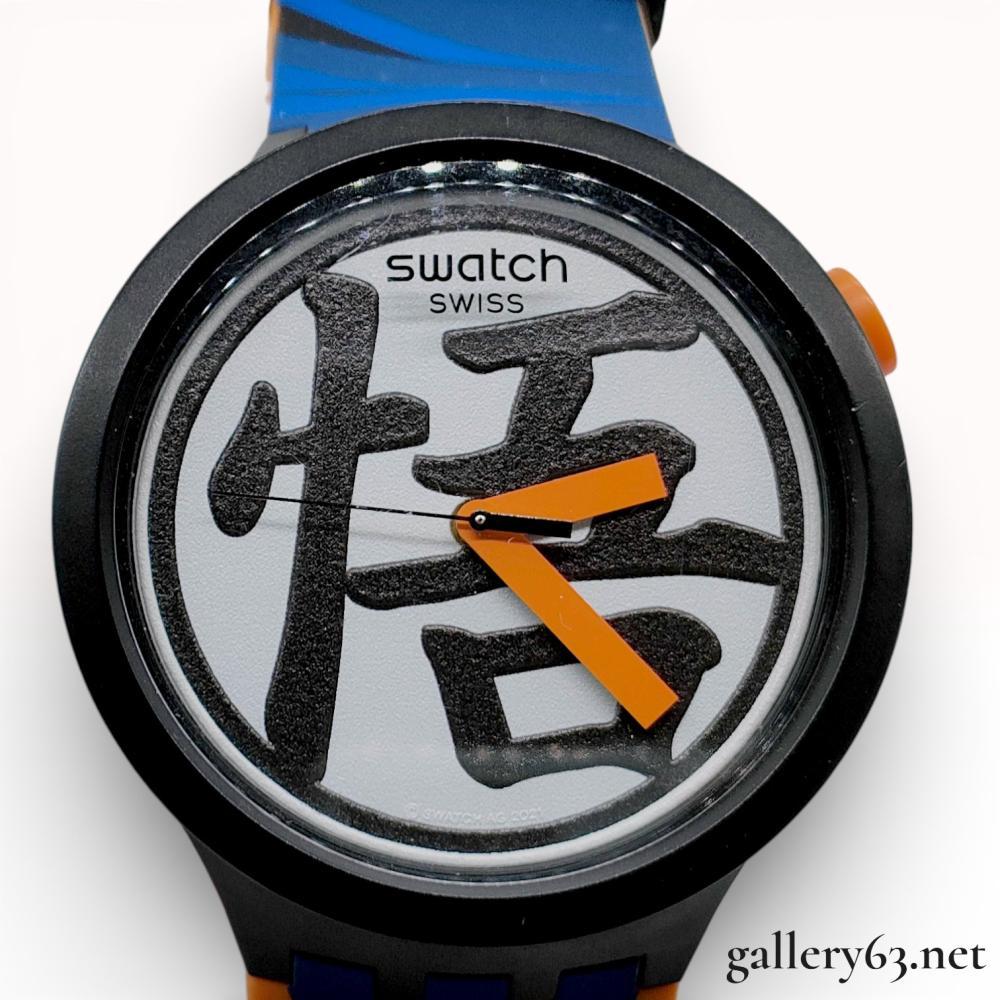 Description
Swatch Big Bold quartz wristwatch from the Dragon Ball Z collaboration, reference SB01Z101, circa 2021. The matte black bioceramic case houses a white dial featuring a textured black kanji symbol and orange baton hands. It is fitted with an original multi-colored silicone strap with themed graphics and includes the original character-illustrated presentation box.
Case size: 46.1 mm.