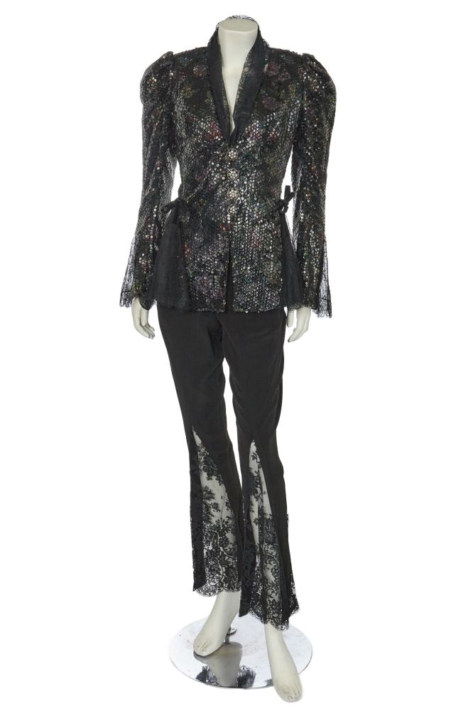 A Chistian Lacroix sequined evening ensemble, circa 1995

A Chistian Lacroix sequined evening ensemble, circa 1995

pink label, size 36, the black and irridescent sequined jacket with black lace collar, lace godets to hips and cuffs, large rhinestone inset filigree metal buttons, bust 86cm, 34in; with pair of matching crêpe trousers with lace godets forming flared hems, waist 61cm, 24in (2)

Share this lot: