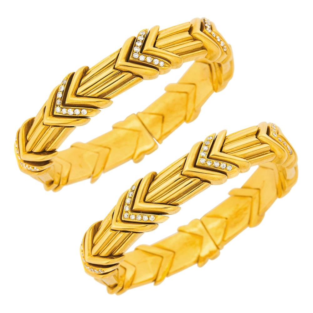Estate of a Florida Lady18 kt., 36 round diamonds ap. .70 ct., both with inner steel linings, ap. 102 dwts. gross. Inner circles 6 1/2 inches.

Diamonds: H-I-VS.Widths 1/2 (chevron bands) and 7/16 (bracelets) inch.                            
Any condition statement is given as a courtesy to a client, is an opinion and should not be treated as a statement of fact and our Organization shall have no responsibility for any error or omission. Please contact the specialist department to request further information or additional images that may be available.