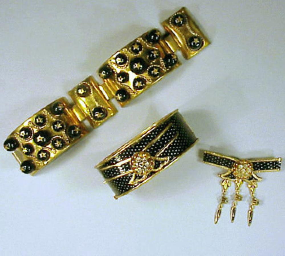 Two Schiaparelli Black and Gold Bracelets 1950s

Lot 473
Two Schiaparelli Black and Gold Bracelets 1950s
 1950s 
 The first with black beads topped with stars, the next an enamel bangle with gold dots; And Pin en suite,the first unmarked, the second marked.