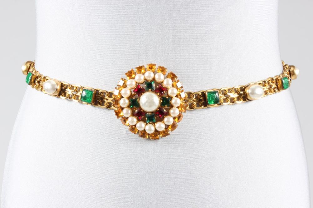 

A Scemama for Yves Saint Laurent couture collection jewelled belt, 1972, signed YSL, the chain links studded with blister ’pearls’ and green stones, with large circular medallion inset with red, green and topaz ’gems’, 71cm, 28in 



This belt worn as a choker is photographed in L’Officiel, no 594 p.331.
