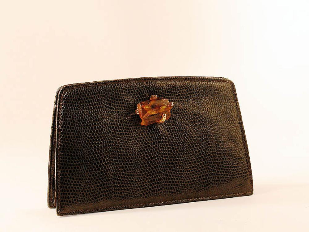 Two Yves Saint Laurent Clutches

Lot 880
Two Yves Saint Laurent Clutches
 The first of mocha brown straw with wood frame and clasp, 10 x 7 inches; the second of dark brown faux reptile with uncut amber stone clasp, 10 x 6 inches, both labeled: Yves Saint Laurent.
Excellent condition, some interior wear.