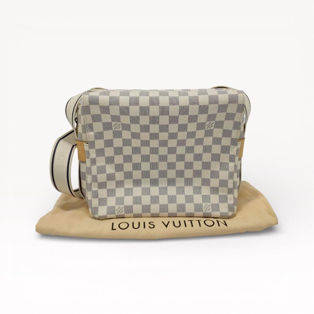 Description
Louis Vuitton Naviglio messenger bag in Damier Azur coated canvas with natural Vachetta cowhide leather trim. The design features a central zippered compartment and two large side pockets beneath a flap secured by two gold-tone snap closures. It is equipped with an adjustable cream textile shoulder strap featuring woven brand lettering and dark blue stripes. An interior leather tab is heat-stamped LOUIS VUITTON PARIS made in France, and the bag is accompanied by a branded textile dust bag.
11" W x 9.5" H x 5.5" D.
