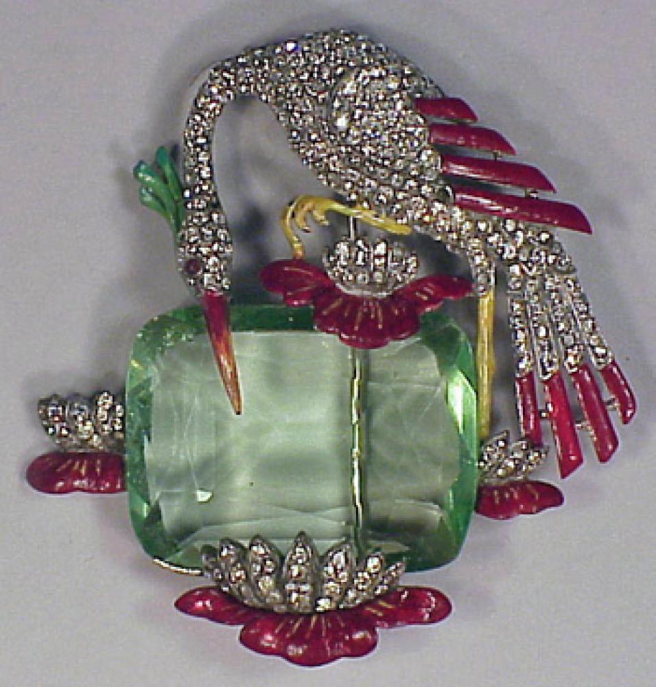 Trifari Stork Pin

Lot 159
Trifari Stork Pin
 Painted enamel stork with rhinestones set against a large green crystal stone. 
 See Cera, Jewels of Fantasy, p.156.